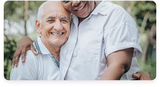 A happy senior couple sitting together in a park
